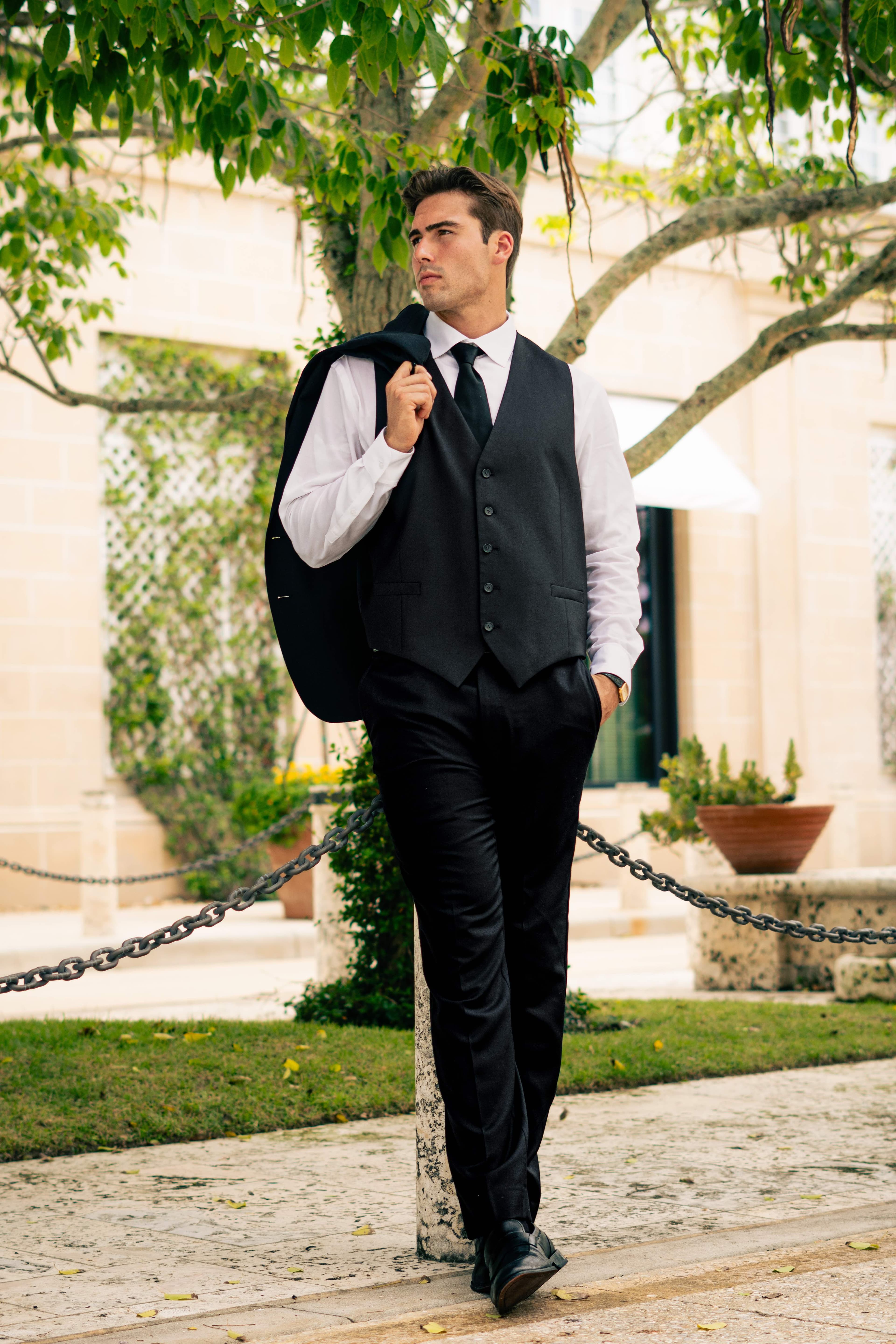 Christian Utne walking in black vest and trousers